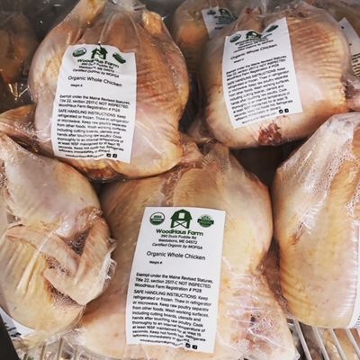 packaged whole chickens with WoodHaus farm logo