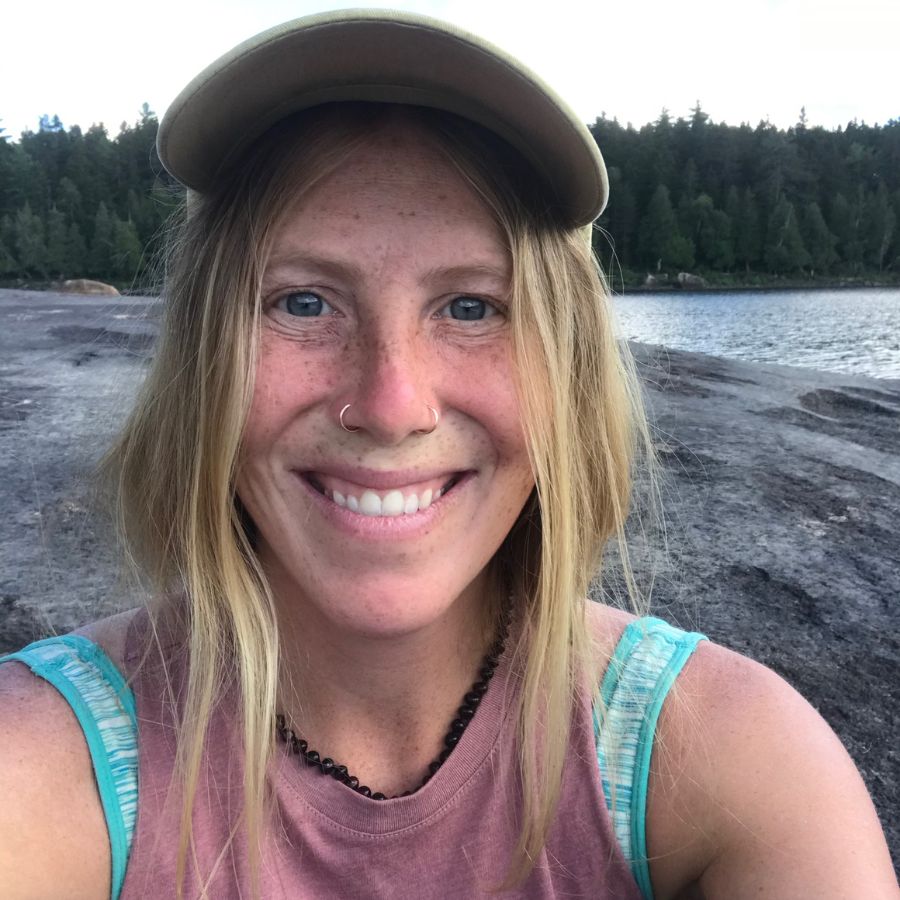 smiling yoga teacher Katheryn by the water in maine.