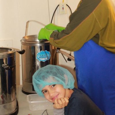 Making cheese in small vats with Kieran in a hair net as a child.